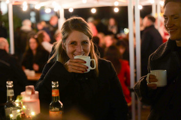 Besucherin des Weihnachtsmarkts der Immanuel Albertinen Diakonie hält eine Tasse Punsch in stimmungsvoller Beleuchtung Besucherin des Weihnachtsmarkts der Immanuel Albertinen Diakonie hält eine Tasse Punsch in stimmungsvoller Beleuchtung